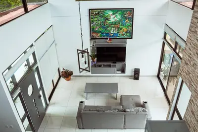 a living room with a couch and a tv at Hector House in Uvita