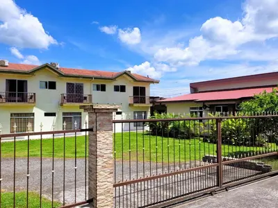a fence in front of a house at Volcano View Apartments in Fortuna