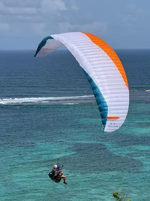 a person in the ocean flying a kite over the ocean at Villa Paraiso do Mar in Jacó