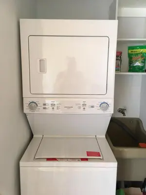 a white refrigerator with a microwave in a kitchen at Villa Paraiso do Mar in Jacó