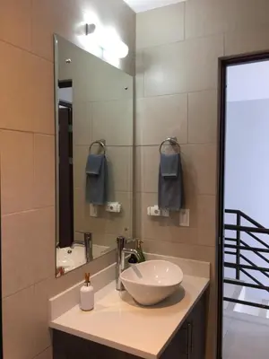 a bathroom with a bowl sink and a mirror at Villa Paraiso do Mar in Jacó