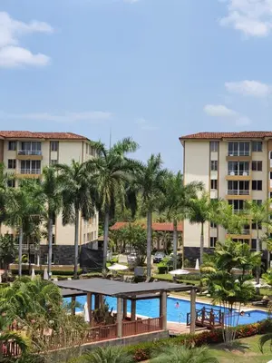 a view of a resort with a pool and palm trees at Paradise Jaco Beach Apartment in Jacó