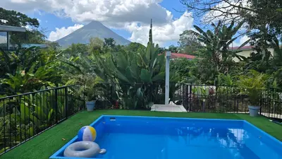 a swimming pool with a mountain in the background at Villas Töcu - Casa Colibrí in Fortuna