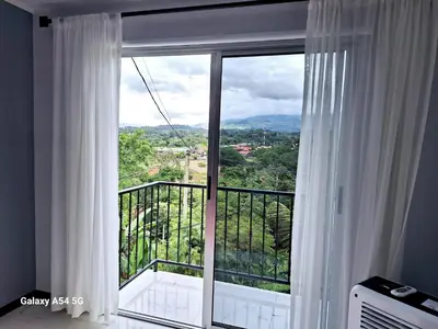 a room with a large window with a view at Casa Victoria CR in San Isidro