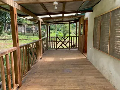 a wooden walkway leading to a porch on a house at Casona La Vieja, Luz del Corazón in Rincón de la Cruz