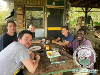 a group of people sitting around a table at Casona La Vieja, Luz del Corazón in Rincón de la Cruz