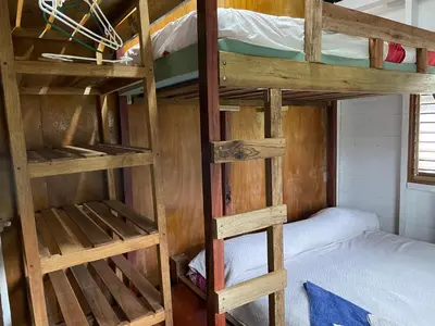 two bunk beds in a room with a bed at Casona La Vieja, Luz del Corazón in Rincón de la Cruz