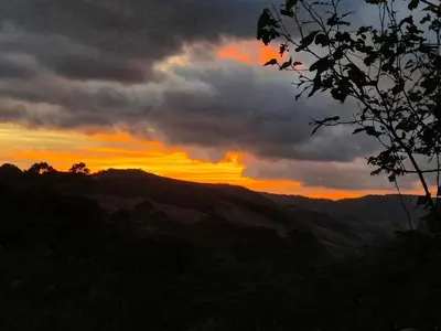 a sunset in the mountains with a cloudy sky at Casa Curré Monteverde in Monteverde Costa Rica