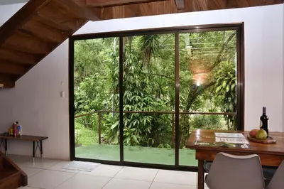 an office with a large glass window and a desk at Casa Curré Monteverde in Monteverde Costa Rica