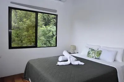 a bedroom with a bed with a stuffed animal on it at Casa Curré Monteverde in Monteverde Costa Rica