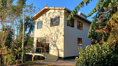 a house with a staircase leading up to it at Casa Curré Monteverde in Monteverde Costa Rica