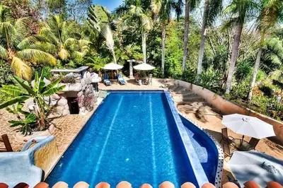 an overhead view of a swimming pool in a resort at Stunning House! Villa Kalapiti - Blue Zone Costa Rica in Delicias