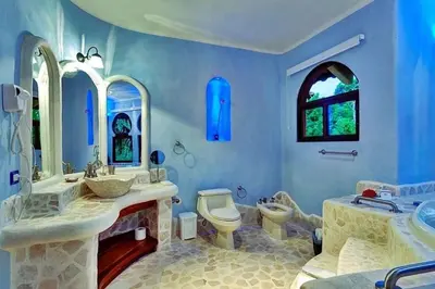 a blue bathroom with two sinks and a toilet at Stunning House! Villa Kalapiti - Blue Zone Costa Rica in Delicias