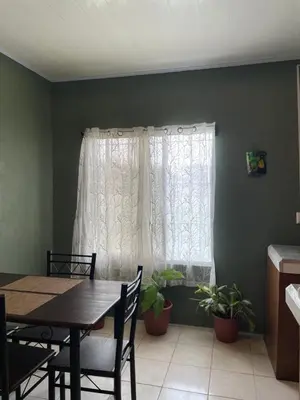 a dining room with a table and a window at Big Sloth Apartment in Fortuna