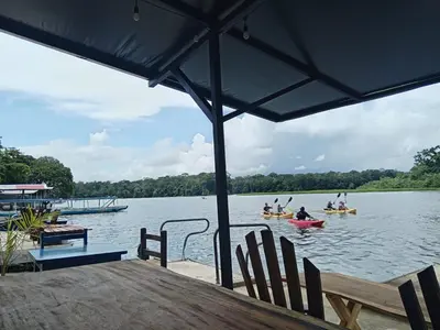 a group of people in kayaks on a lake at Hotel Pura Natura Riverside Tortuguero in Tortuguero