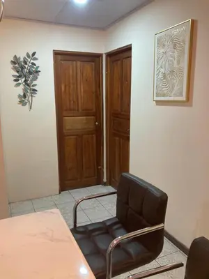 a conference room with a chair and a door at Hospedaje Ana Lu 1 Only 10 minutes from airport in Alajuela City