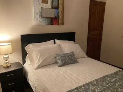 a bedroom with a bed with a pillow on it at Hospedaje Ana Lu 1 Only 10 minutes from airport in Alajuela City