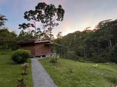 a small building in the middle of a field at Siquirres Mountain Lodge in Siquirres