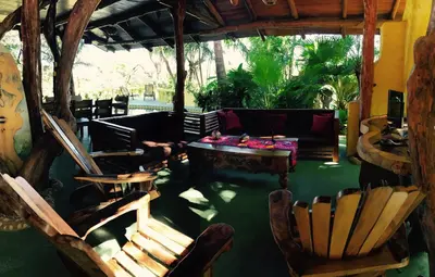 a living room with a couch and a table and chairs at Nosara Sunrise Bed and Breakfast in Nosara