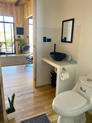 a bathroom with a sink and a toilet in a room at Cabaña Grande océan and jungle Infinity swim pool in Santa Teresa Beach