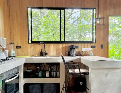 a kitchen with a sink and a window at Cabaña Grande océan and jungle Infinity swim pool in Santa Teresa Beach