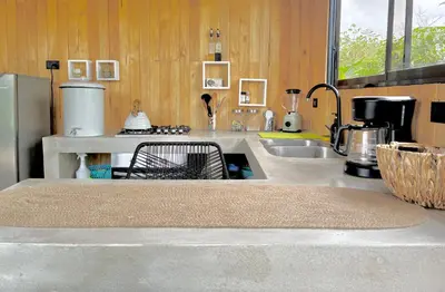 a kitchen with a sink and a counter top at Cabaña Grande océan and jungle Infinity swim pool in Santa Teresa Beach