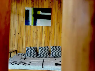a bedroom with a bed and a painting on the wall at Cabaña Grande océan and jungle Infinity swim pool in Santa Teresa Beach