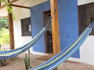 a hammock in front of a house at La casa del Artesano !Casa completa frente al mar! in Santa Cruz