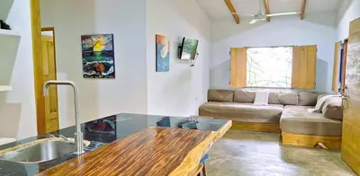 a kitchen and living room with a sink and a couch at La casa del Artesano !Casa completa frente al mar! in Santa Cruz