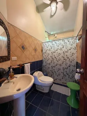 a bathroom with a toilet and a sink at Yethan house in Uvita