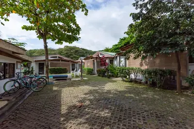 a courtyard of a house with bikes parked in the yard at Maoritsio Garden Studios in Santa Teresa Beach