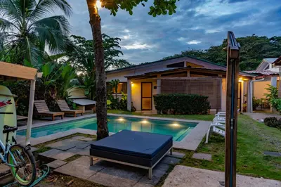 a villa with a pool and a house at Maoritsio Garden Studios in Santa Teresa Beach
