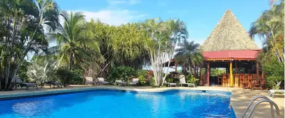 a swimming pool in a resort with a gazebo at Guacamaya Lodge in Paraíso