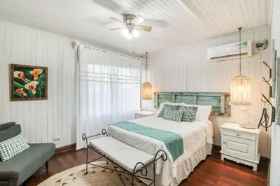a bedroom with a bed and a chair in it at Hotel Punta Descartes in La Cruz