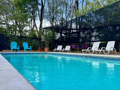 a group of chairs and a swimming pool at Tucan Hotel in Uvita
