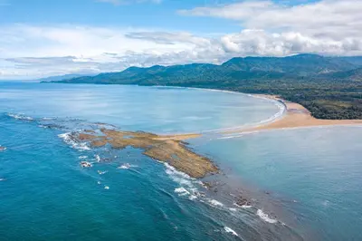 an aerial view of a beach and the ocean at Tucan Hotel in Uvita