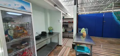a room with a refrigerator and a table in it at Tucan Hotel in Uvita