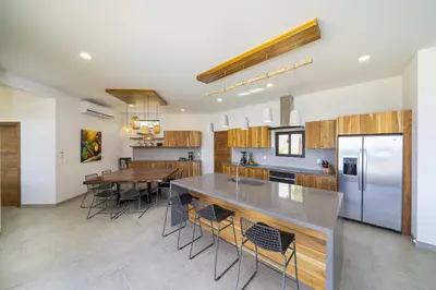 a kitchen with a table and a dining room at Villa Vista Pacifico - Serene Villa, Ocean View Pool, Rooftop Deck, 5 BR in Potrero