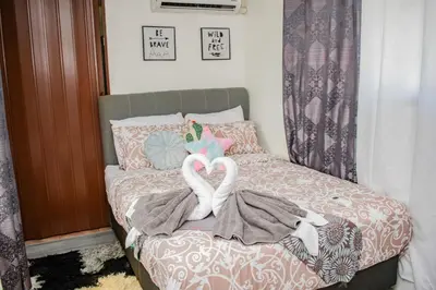 two swansuitsrendered to look like hearts on a bed at Arenal Tiny Houses - STAR in Fortuna
