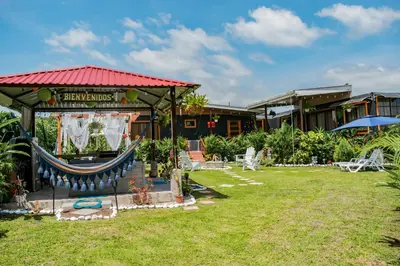 a resort with a hammock in the yard at Arenal Tiny Houses - STAR in Fortuna
