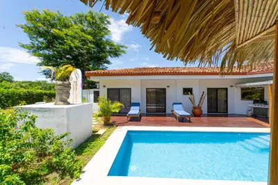 a villa with a swimming pool and a house at Casa Callie- 3 Bedroom House With Pool in Tamarindo