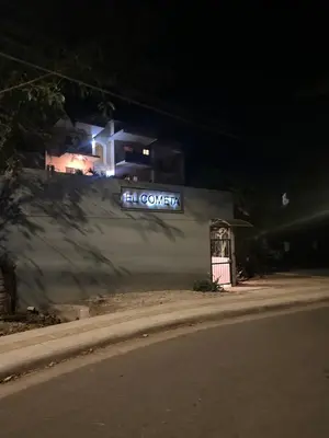 a sign on the side of a building at night at Tamarindo Gem: 1BR Apt in Heart! in Tamarindo