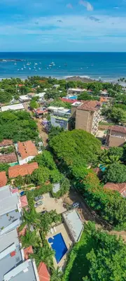 an aerial view of a city with the ocean at Tamarindo Gem: 1BR Apt in Heart! in Tamarindo