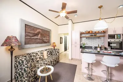 a kitchen and living room with a couch and a table at Tamarindo Gem: 1BR Apt in Heart! in Tamarindo