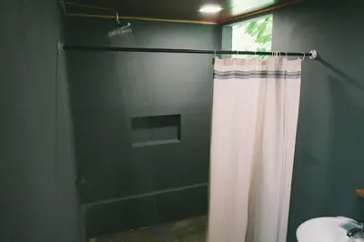 a shower with a shower curtain in a bathroom at Toku in Fortuna