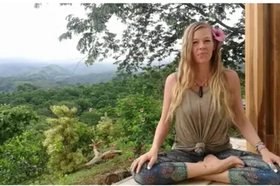a woman sitting on a window sill in meditation at Luxury Villa Caoba- Private, Serene, Amazing Views at Finca Chilanga in San Mateo