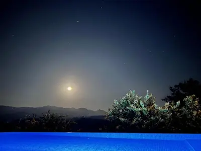 a pool at night with the moon in the sky at Luxury Villa Caoba- Private, Serene, Amazing Views at Finca Chilanga in San Mateo