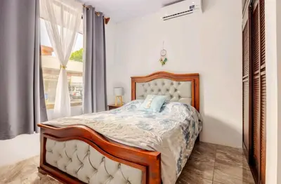 a bedroom with a bed and a window at Casa en Playa Tambor - A 5 minutos de la playa in Tambor
