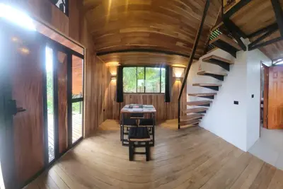 a hallway of a house with a wooden ceiling and stairs at Myra Chalets in Bijagua