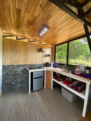 a kitchen with wooden ceilings and a counter top at Myra Chalets in Bijagua